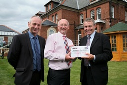 Dave Allan (left) and Robert Goodwill (right) present the Excellence in Care Standard award to Peregrine House owner Dr Kevin O'Sullivan