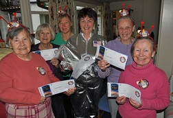 Karen Luke, healthcare assistant (third left), Shirley Smith, activities organiser (centre) with residents with their NASA boarding passes at Colten Care's Woodpeckers home.