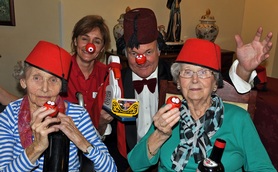 Tommy Cooper impersonator Clive Greenaway with Canford Chase activities organiser Maria Grant and residents Jean Palmer and Sylvia Sansome