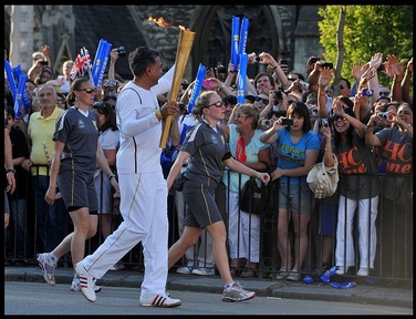 Chairman of HC-One, Dr Chai Patel carrying the Olympic Torch on Tuesday 24th July  