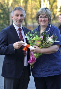 Coverage Care's chief executive David Coull presents Liz Dorricott her award for 25 years Service