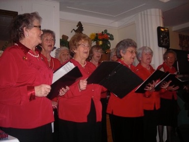 A choir entertains Regal residents with traditional Christmas carols