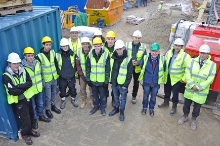 With the Newbury College students at the Linden House site are: Brian Evans, curriculum manager (third from right); George Colwell, joint managing director, Colten Developments (second from right); and Bob Doran, contracts manager, Colten Developments (right).   