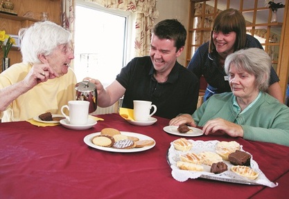 Andrew Cannon pouring tea in a Bupa care home