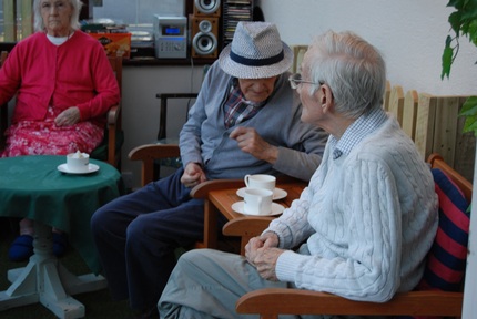 Residents converse over the unusual crockery