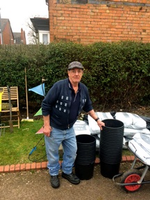 Frank Hopkins with the donation of gardening supplies