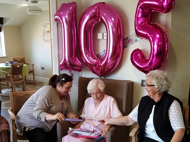 Ivy opening cards and presents on her birthday. Photo courtesy of Addison Court.