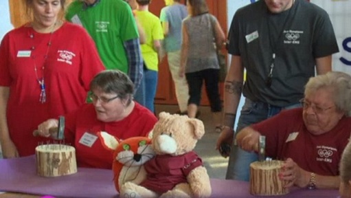 Competitors take part in the hammering nails on wood event