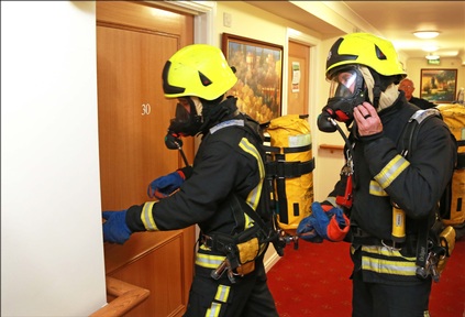Firefighters prepare to check a bedroom at Braemar Lodge care home