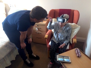 Mr Stokeld helping a care home resident to participate in a virtual reality reminiscence session