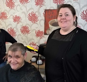 Care home manager Helen Wood finishes the shave. Credit:The Beeches Care Home