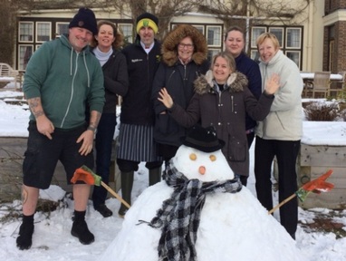 Snow idea when shift will end: Hayley Hirst (front right) with staff outside Brooke House care home Credit: Kingsley Healthcare