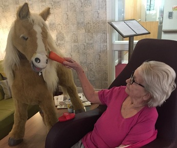 Mary and the robotic pony/ Credit: Oakland Care