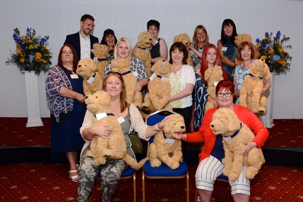 Care home managers from Care South with their robotic dogs