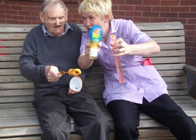 Resident Derek Grassie and activities coordinator Angela Hedley Credit: The Oaks Care Home