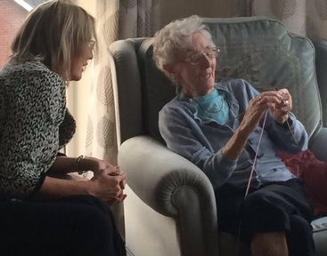 Care minister gets knitting tips from Rhona at Arden Grove care home. Credit: Accord.