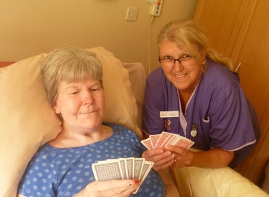 Residents can play cards and other games with staff at their bedside. Credit: KRG Healthcare