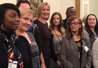 Care Minister Caroline Dinenage with care workers whose portraits feature in the exhibition. Credit: Angeline  Albert