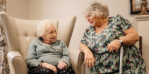Actress Miriam Margolyes talking to a resident at Lavender Fields care home