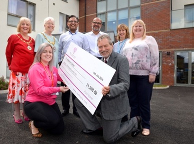 Actor John Middleton with care home staff presenting £1,000 cheque to Alzheimer's Society. Credit: Rochcare
