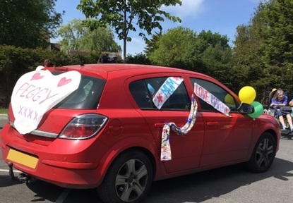 Drive through parade featured decorated cars. Credit: Gracewell of Bookham