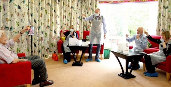100 year old's family raise a toast to him at his surprise party. Credit: Colten Care