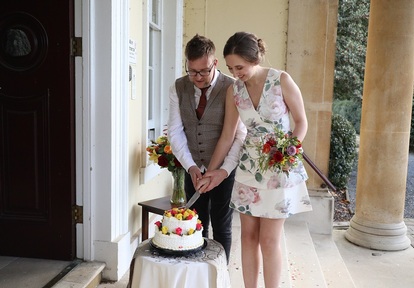 Tom and Kathryn Law cutting their wedding cake at the care home. Credit: The Royal Masonic Benevolent Institution Care Company (RMBI)