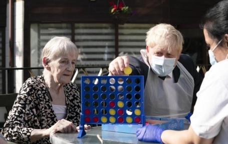 Before announcement, Boris Johnson plays Connect 4 at Westport Care Home. Credit: Westport Care Home