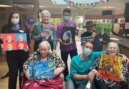 Staff and residents at Sandfields Care Home holding their artwork. Credit Care UK