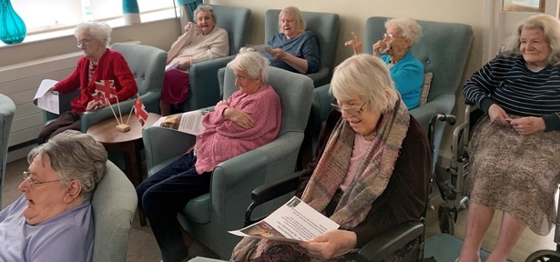 Residents at The Sycamores care home watch  wreaths being laid on TV at the cenotaph in London on Remembrance Sunday. Credit: HC-One