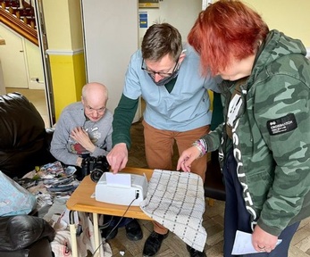 North Norfolk MP Duncan Baker helps resident with photography. Credit: Duncan Baker