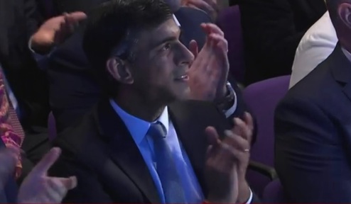 Rishi Sunak, who lost the Conservative leadership battle, listening to Liz Truss' victory speech. Credit: BBC