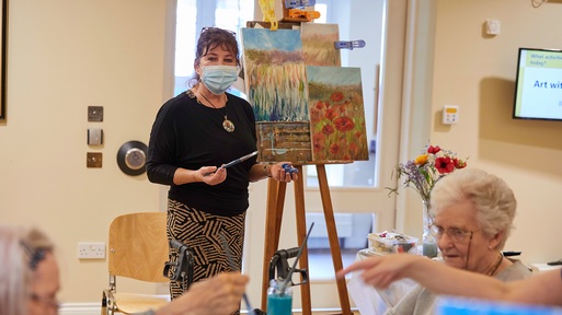 Lucy Freud teaching residents to paint. Credit: Royal Star & Garter.
