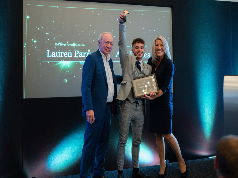 Chef Ashley Davies holding up his award with Mike Parsons and Helen Davies-Parsons at the Dormy Care Awards. Credit: Dormy Care.