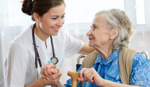 An older lady receives nursing care in a care home from a nurse