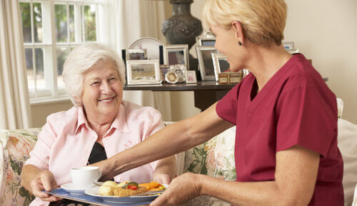 An older lady taking advantage of having her meals cooked for her in a care home